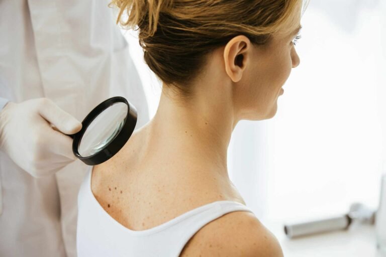 cropped-view-of-dermatologist-holding-magnifying-g-A6SL72N.jpg