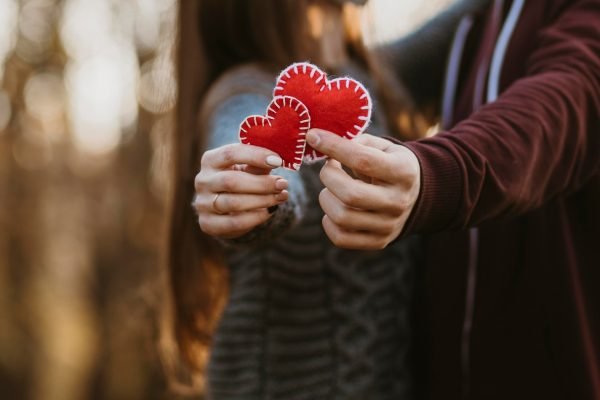 close-up-couple-holding-little-hearts_23-2148755768